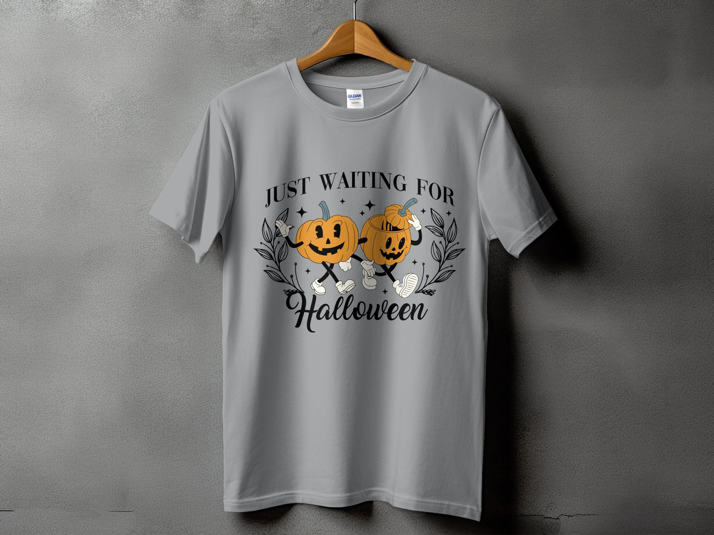 Grey t-shirt with two cartoon pumpkins and text that says "JUST WAITING FOR Halloween".