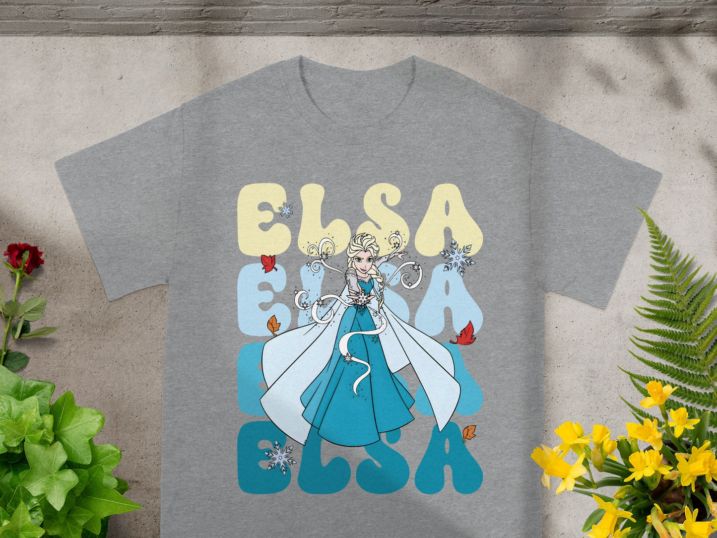 Grey t-shirt with Elsa's name in large blue lettering and an illustration of Elsa.