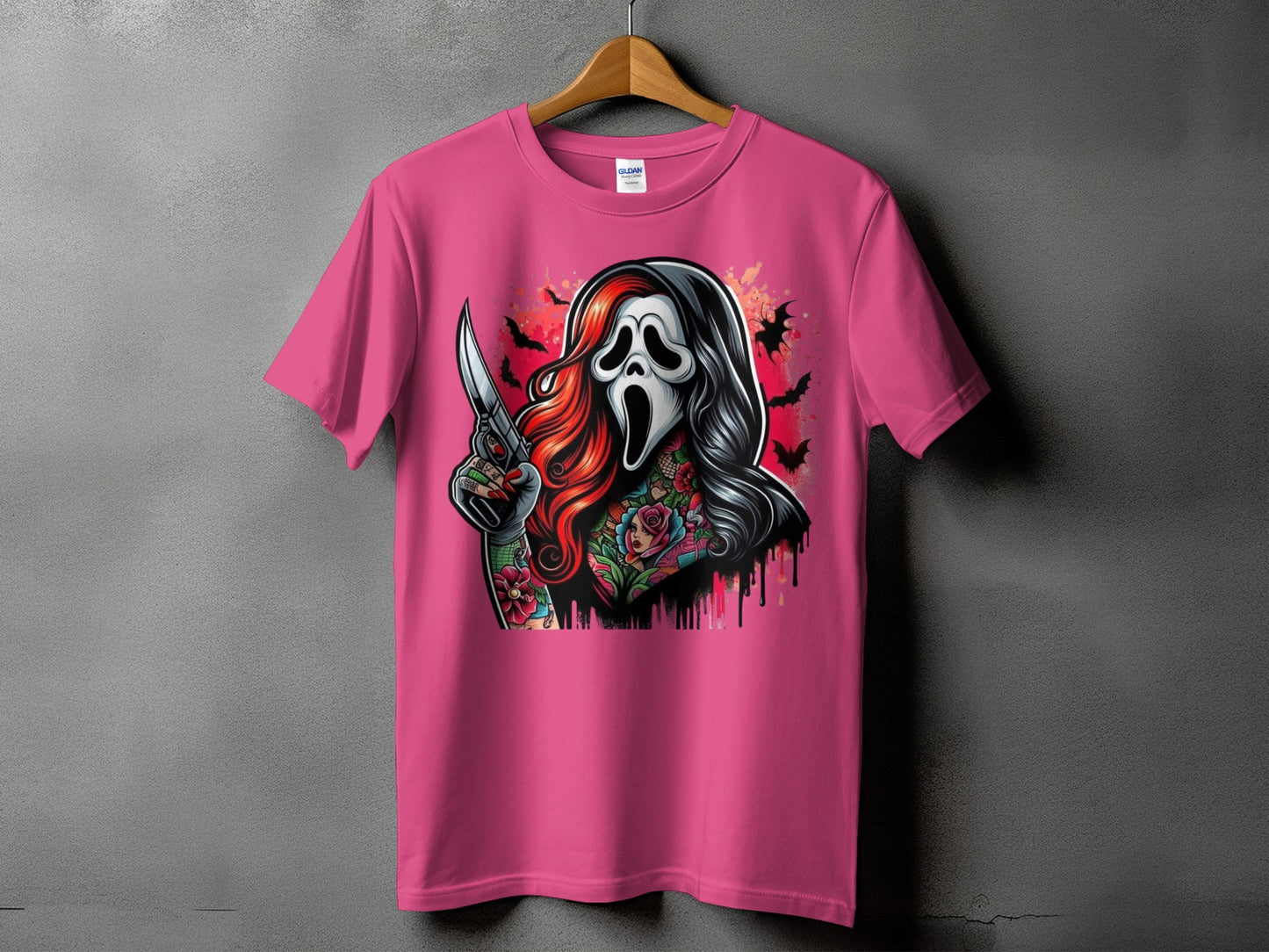 Pink t-shirt with graphic of masked figure holding knife and floral tattoos.