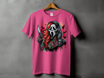 Pink t-shirt with graphic of masked figure holding knife and floral tattoos.