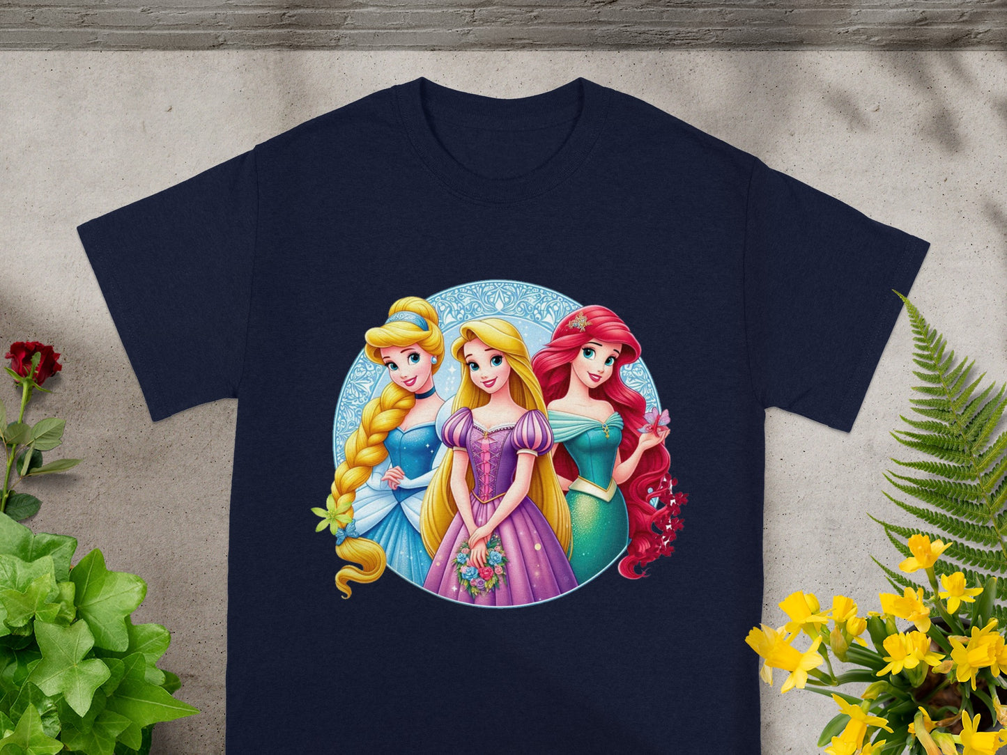 Three Disney princesses, Ariel, Cinderella, and Aurora, on a navy t-shirt.