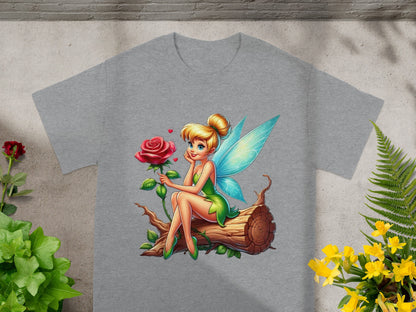 Fairy with blue wings and green dress sitting on a log with a rose.