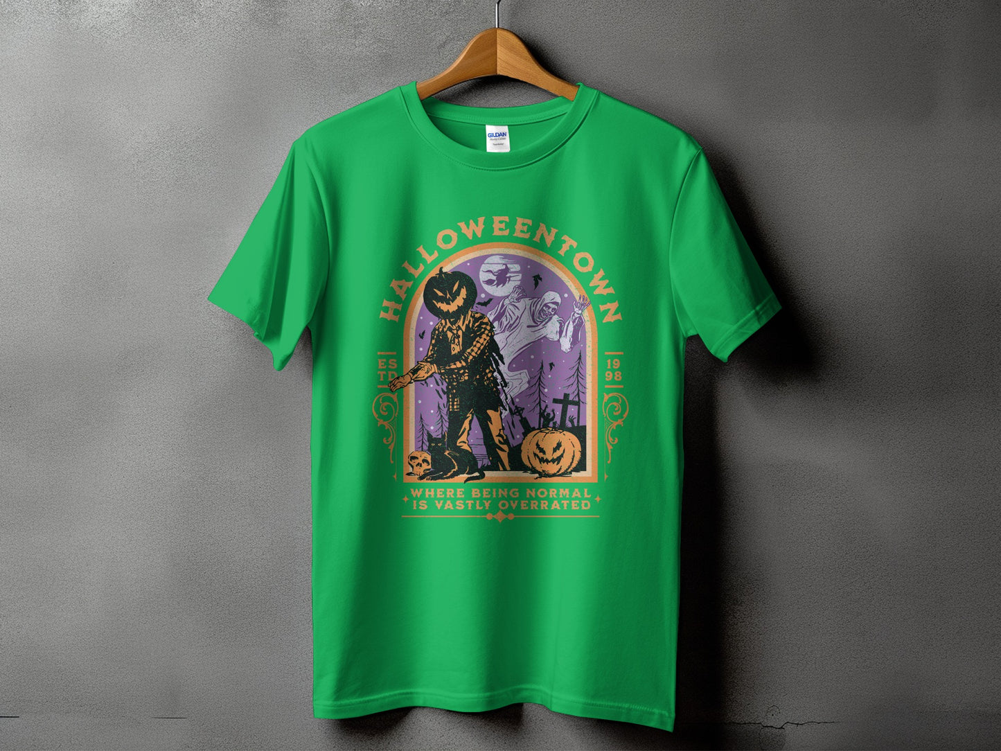 Green t-shirt with a Halloween graphic featuring a scarecrow, ghosts, and text.