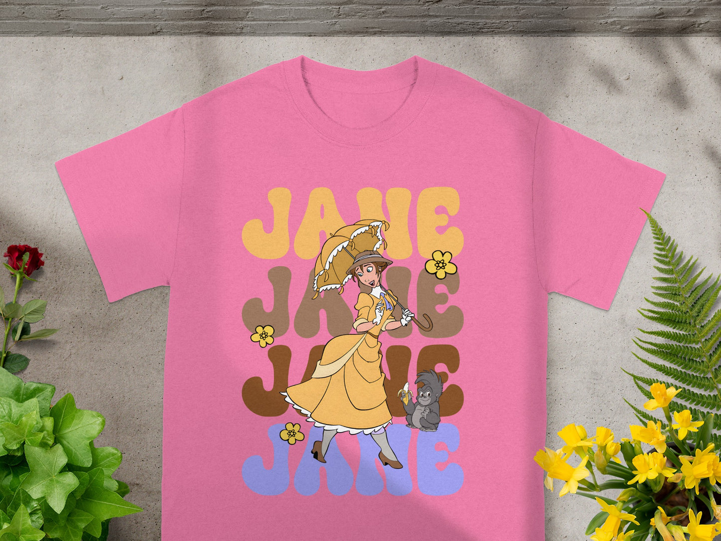 Pink t-shirt with Jane, umbrella, and monkey graphic.