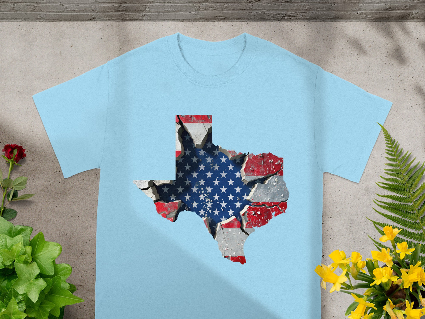 Light blue t-shirt with a cracked Texas map design featuring the American flag.