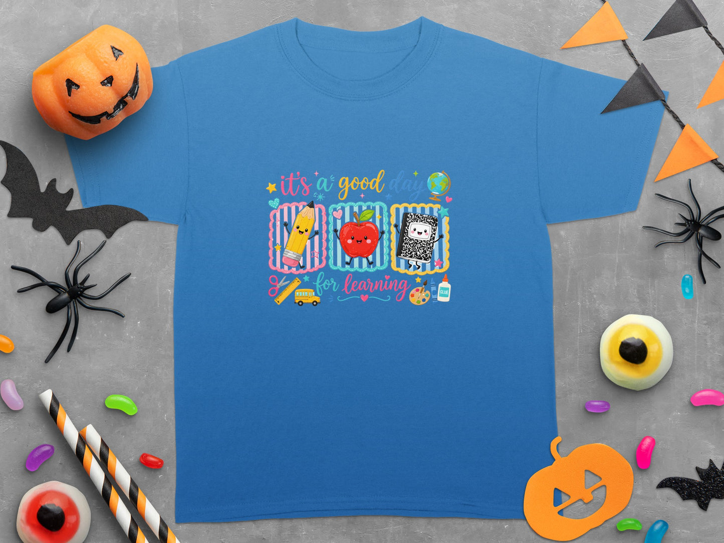 "It's a good day for learning" text with school supplies and Halloween decorations.