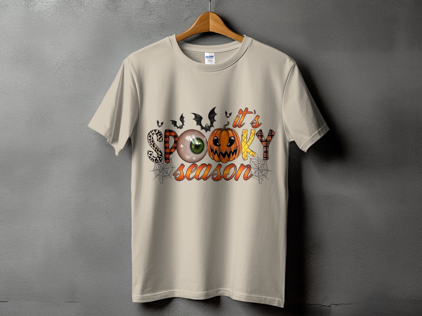 Light beige t-shirt with "it's SPOOKY season" Halloween graphic.