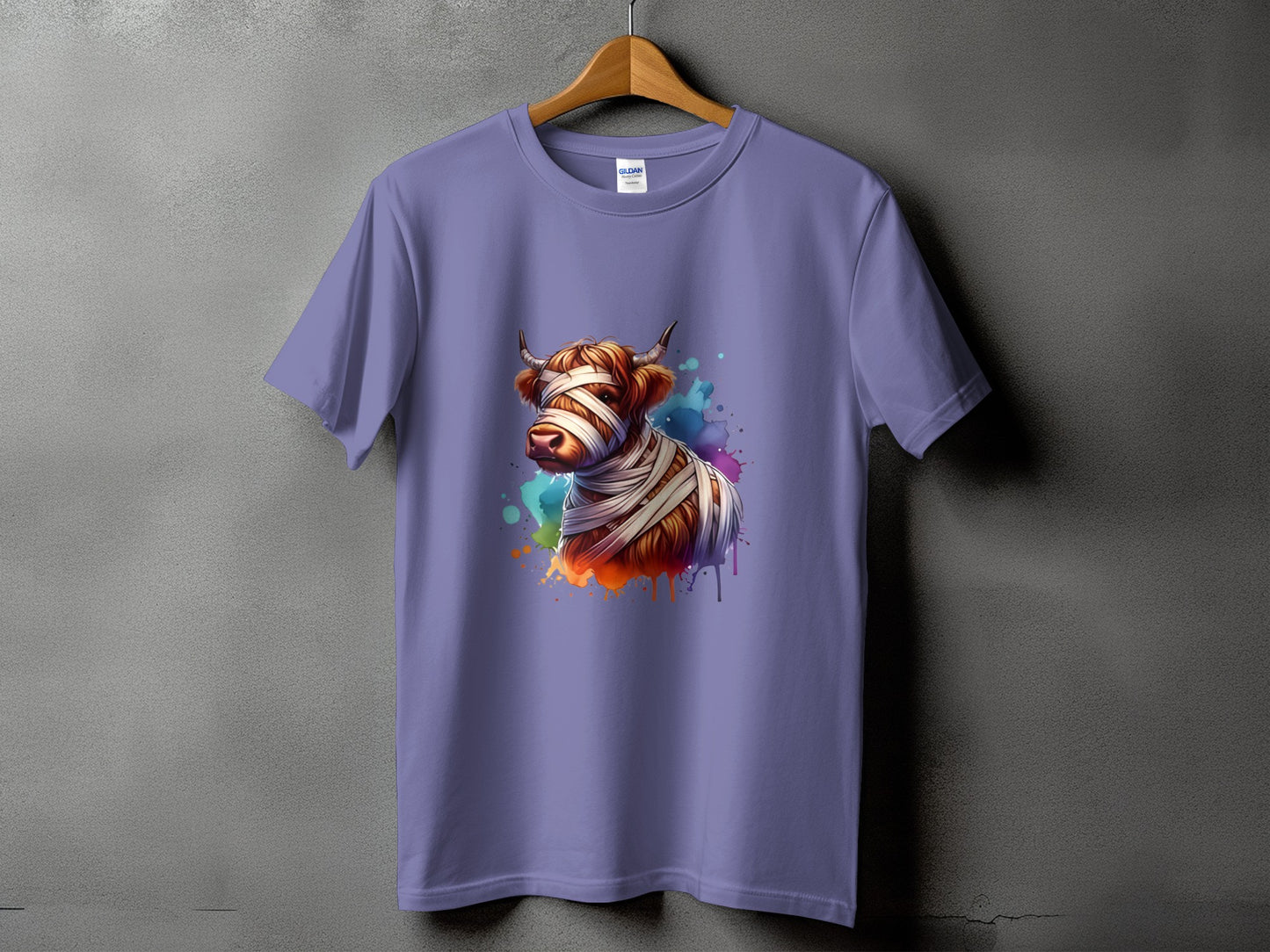 Lavender t-shirt with a watercolor mummy highland cow graphic and colorful splashes.