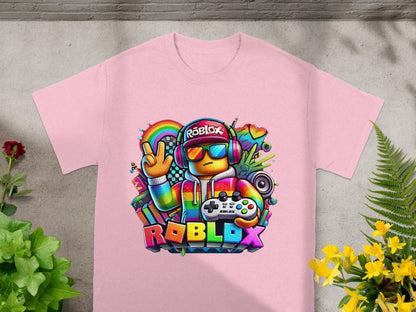 Roblox character with rainbow, headphones, and controller on pink t-shirt.