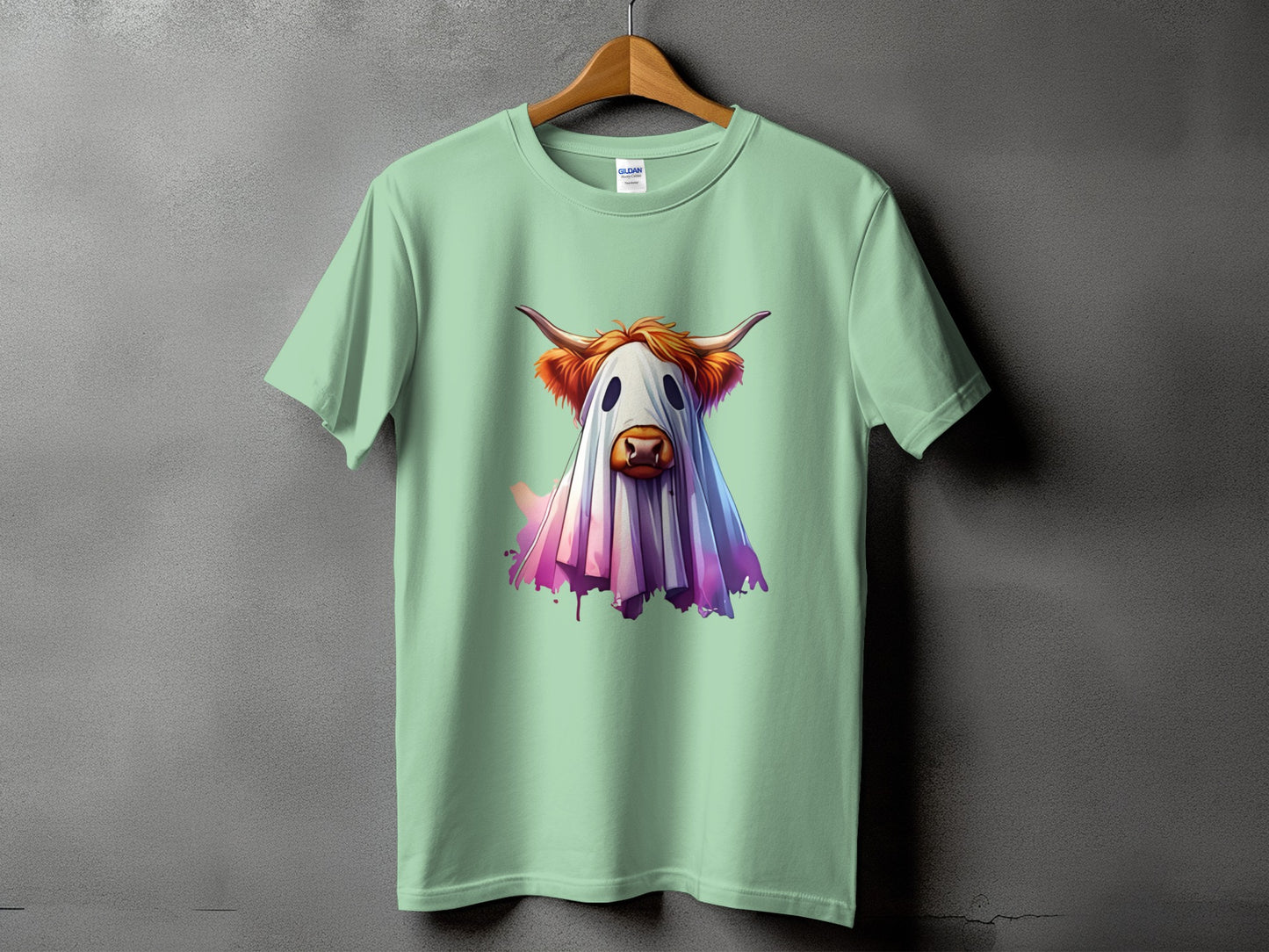 Mint green t-shirt with a highland cow dressed as a ghost graphic.