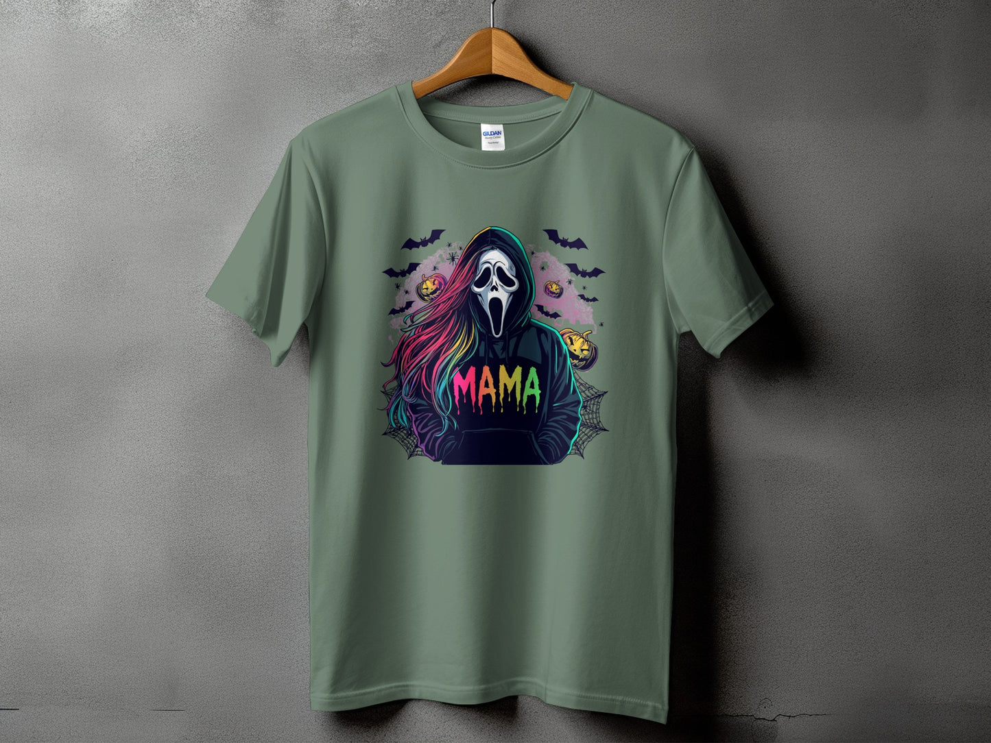 Green t-shirt with a Scream mask character and "MAMA" text, surrounded by Halloween motifs.