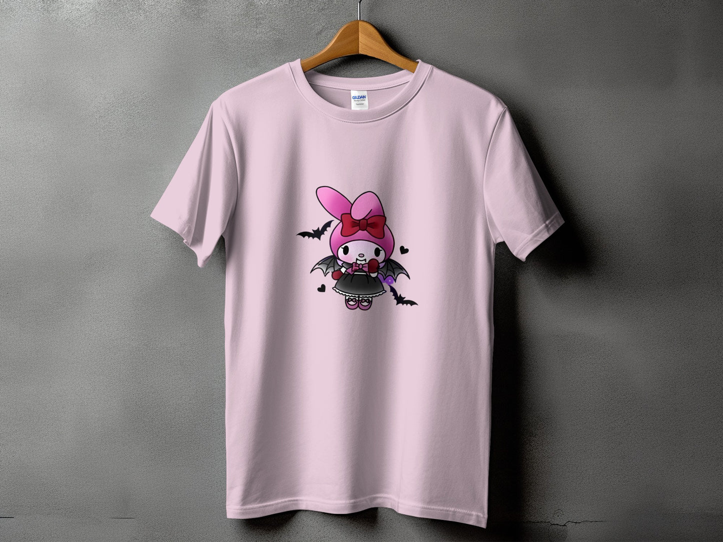 Pink t-shirt with a cartoon bunny character in a black dress and bat wings.