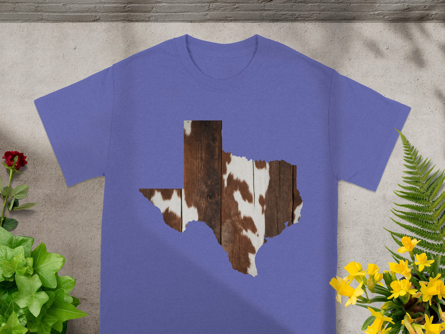 Purple t-shirt with Texas shape filled with wood and cowhide texture.
