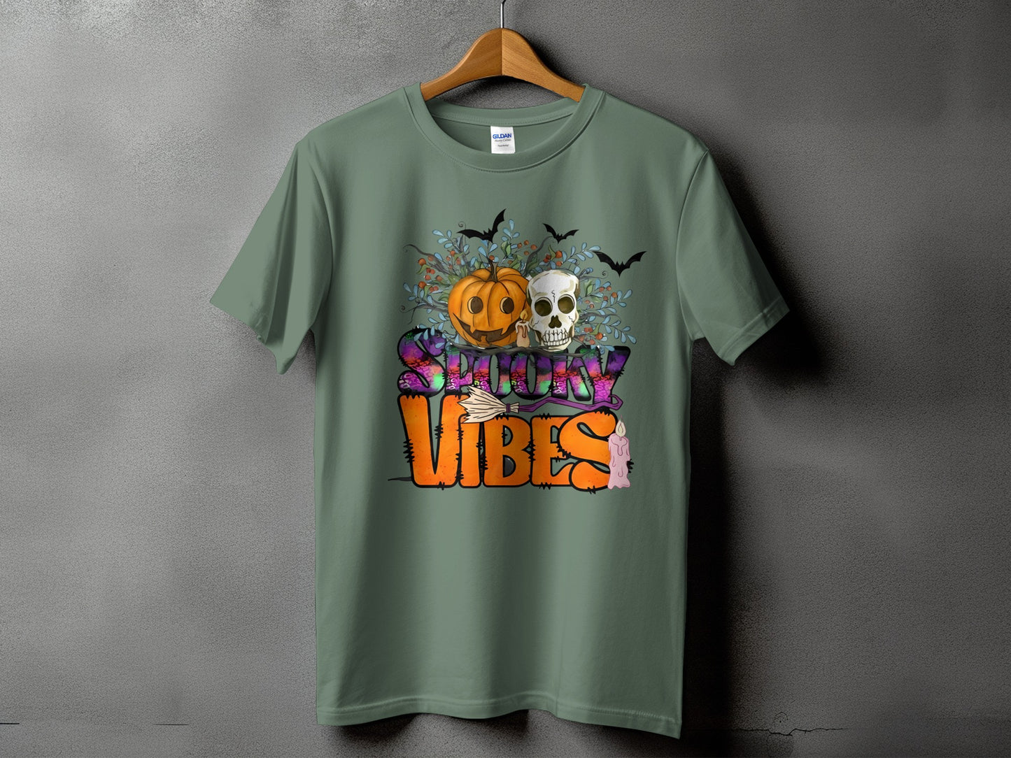 Green t-shirt with "Spooky Vibes" Halloween graphic featuring a pumpkin, skull, bats, and candle.