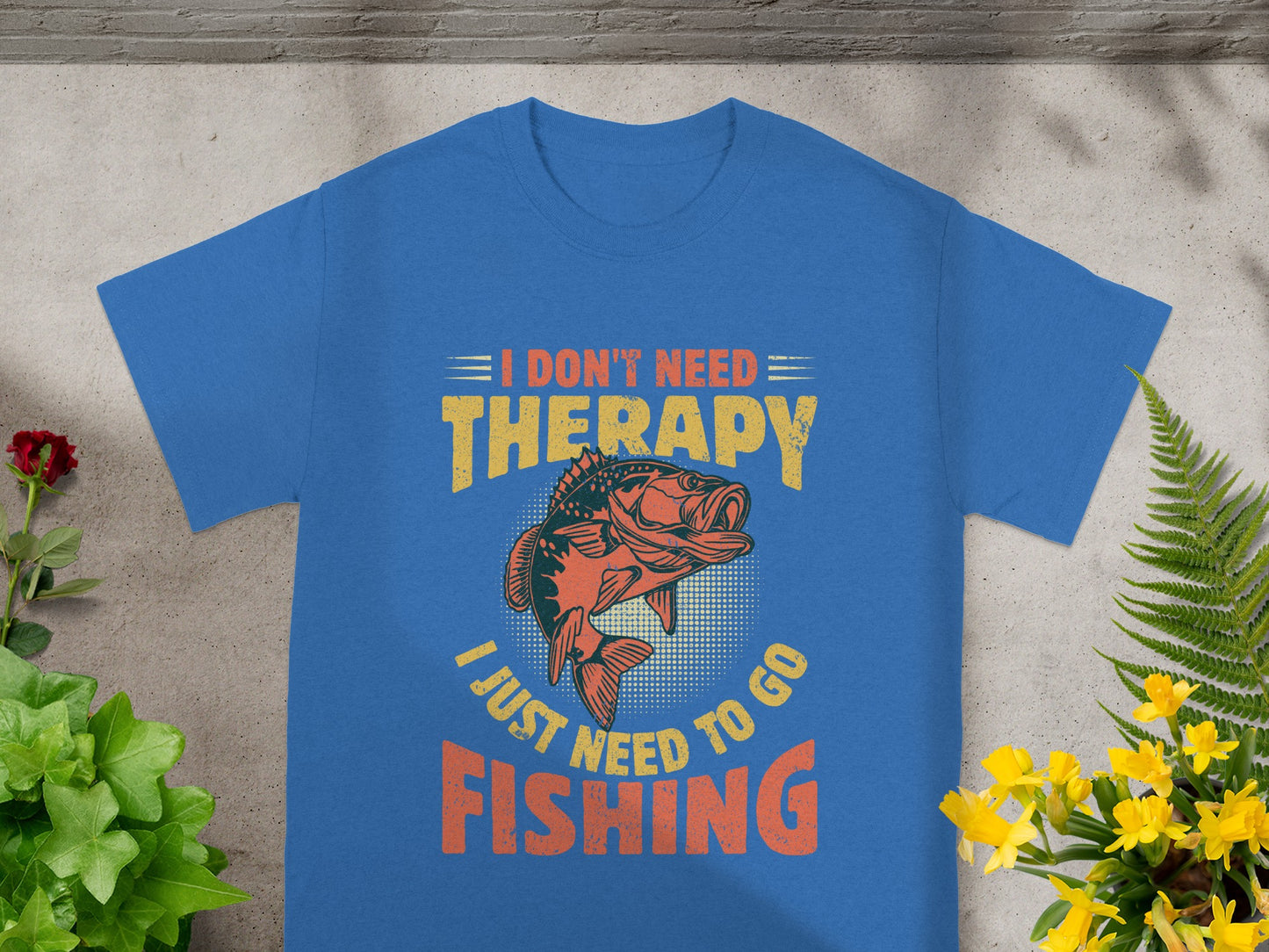 Blue t-shirt with text "I DON'T NEED THERAPY I JUST NEED TO GO FISHING" and fish graphic.