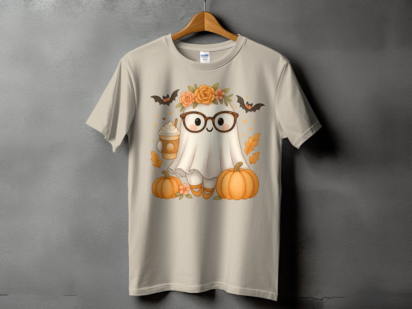 Cute ghost wearing glasses with pumpkins, bats, coffee, and flowers on tan t-shirt.