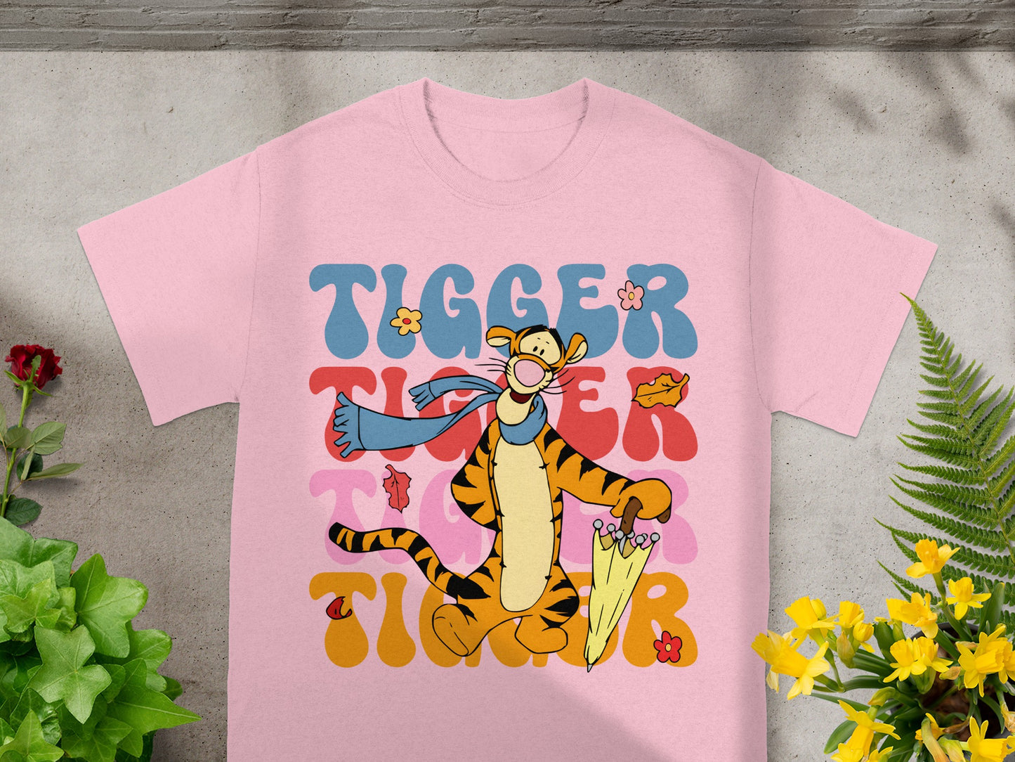 Pink t-shirt with Tigger and "Tigger" text in colorful wavy font.