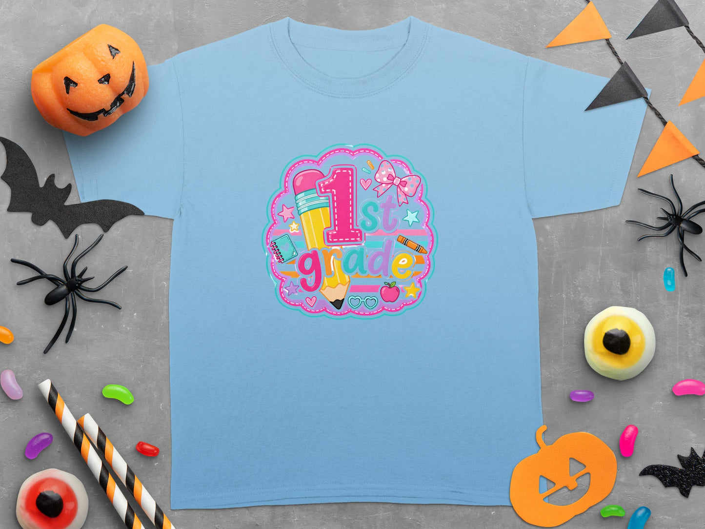 Light blue t-shirt with "1st grade" design featuring pencil, apple, and bow.