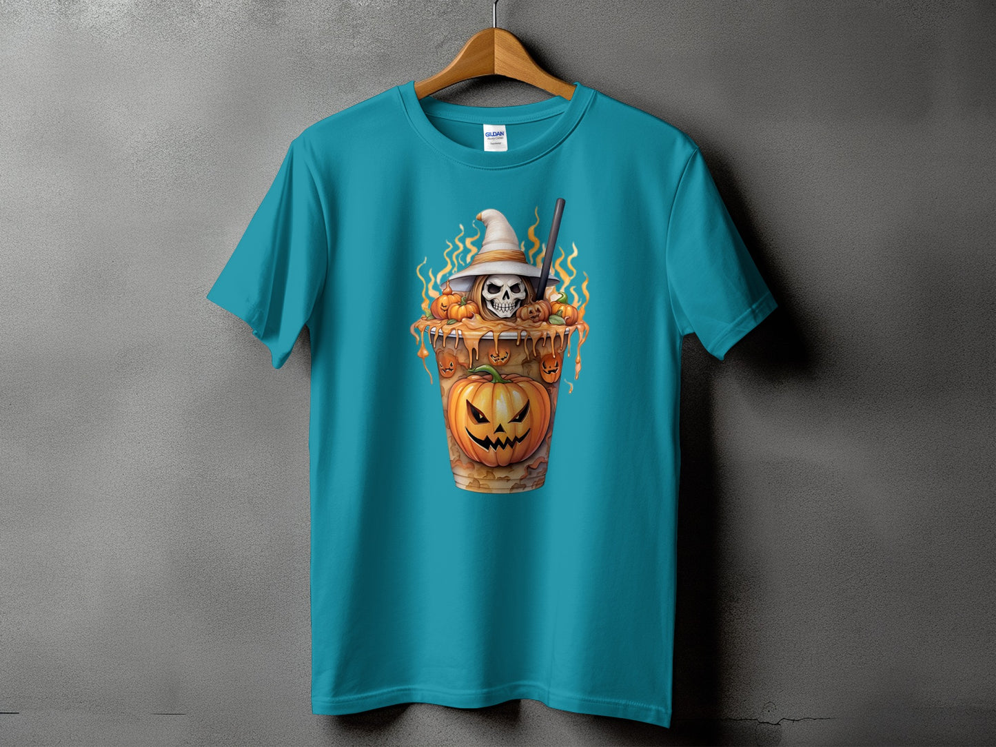 Teal t-shirt with a Halloween-themed graphic of a skull wearing a witch hat and pumpkins.