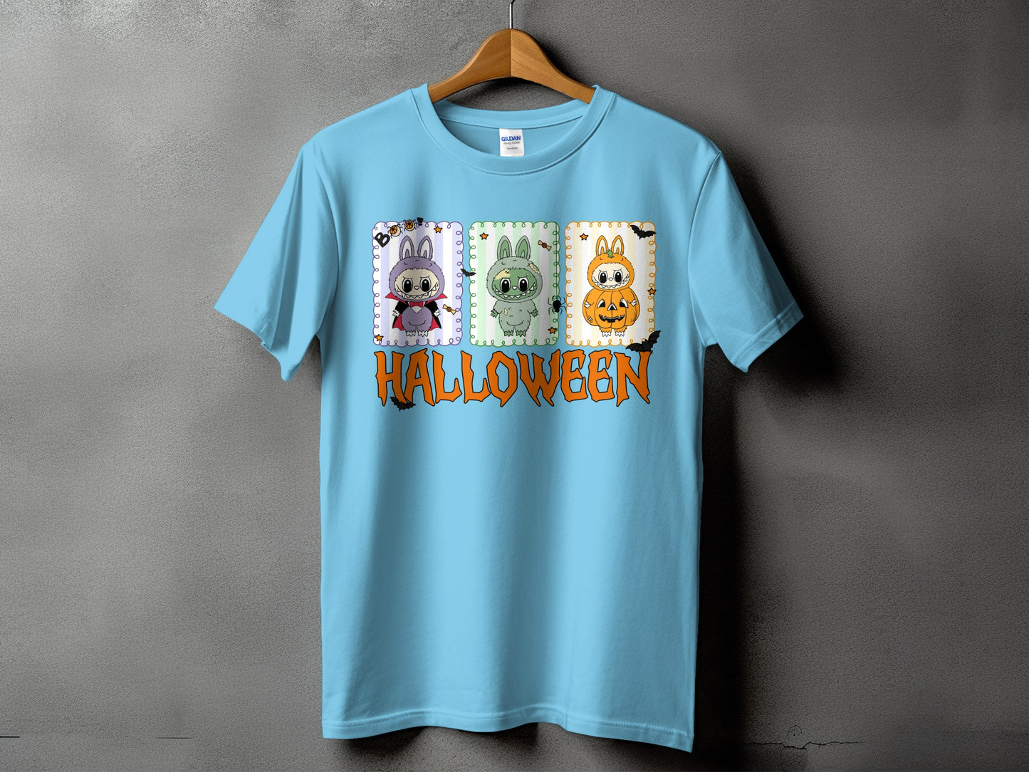 Light blue t-shirt with three Halloween-themed cartoon characters and the word Halloween.