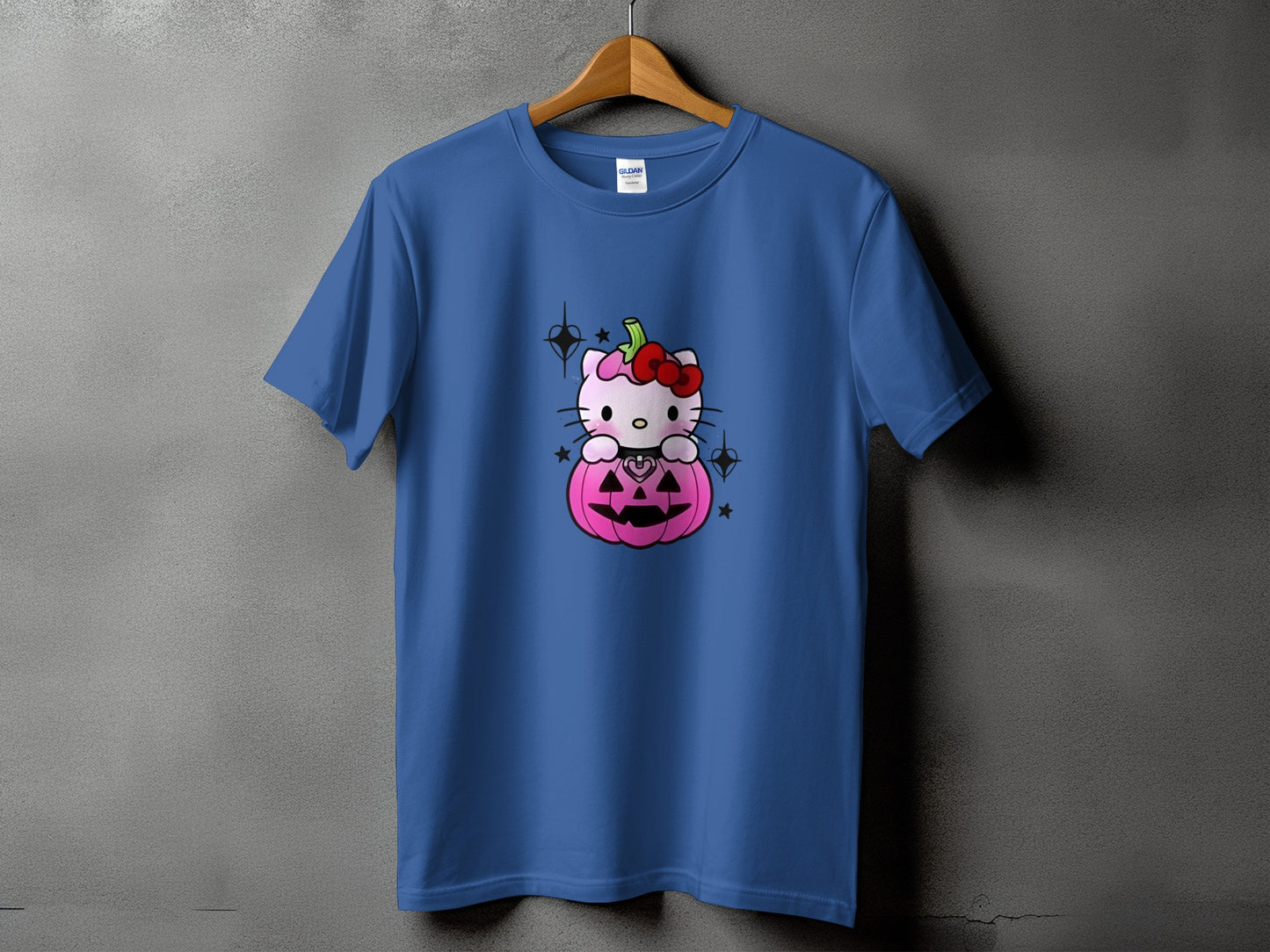 Blue t-shirt with Hello Kitty sitting in a pink jack-o'-lantern on the front.