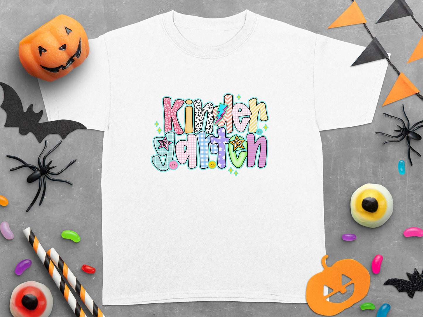 White t-shirt with "Kindergarten" text in colorful, patterned letters.