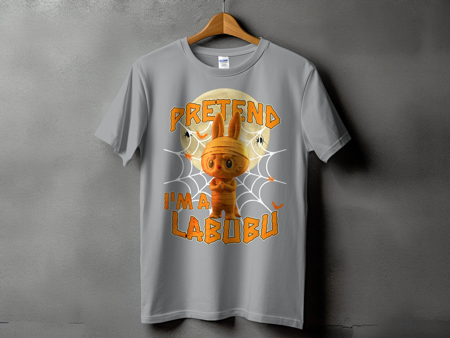 Grey t-shirt with mummy Labubu character and text "PRETEND I'M A LABUBU".