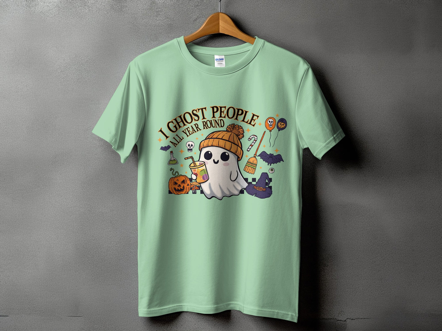 Light mint t-shirt with "I ghost people all year round" text and Halloween graphics.