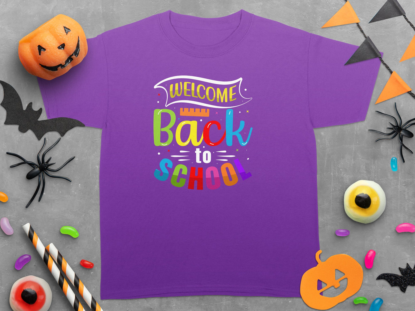 Purple t-shirt with "Welcome Back to School" text and Halloween decorations.