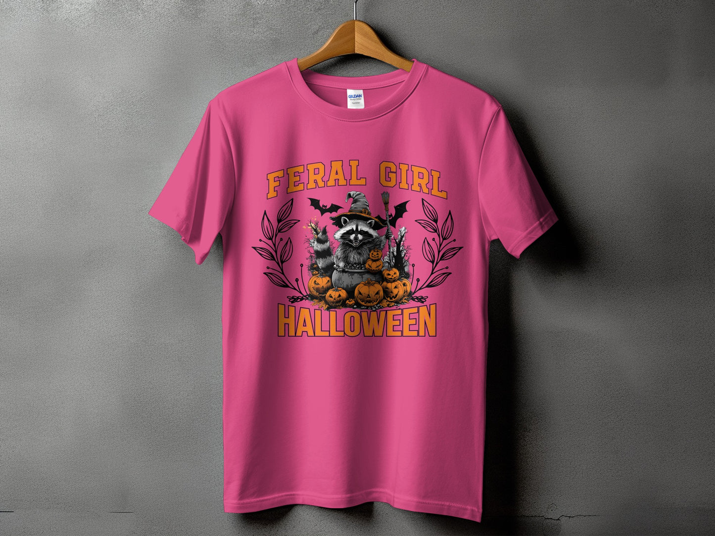 Pink t-shirt with Halloween raccoon graphic and text "FERAL GIRL HALLOWEEN".