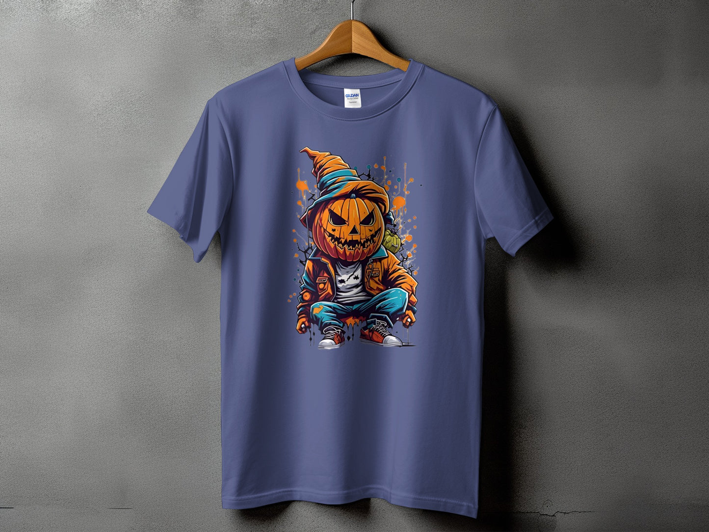 T-shirt featuring a squatting cartoon pumpkin character with a jack-o'-lantern face and Halloween hat.