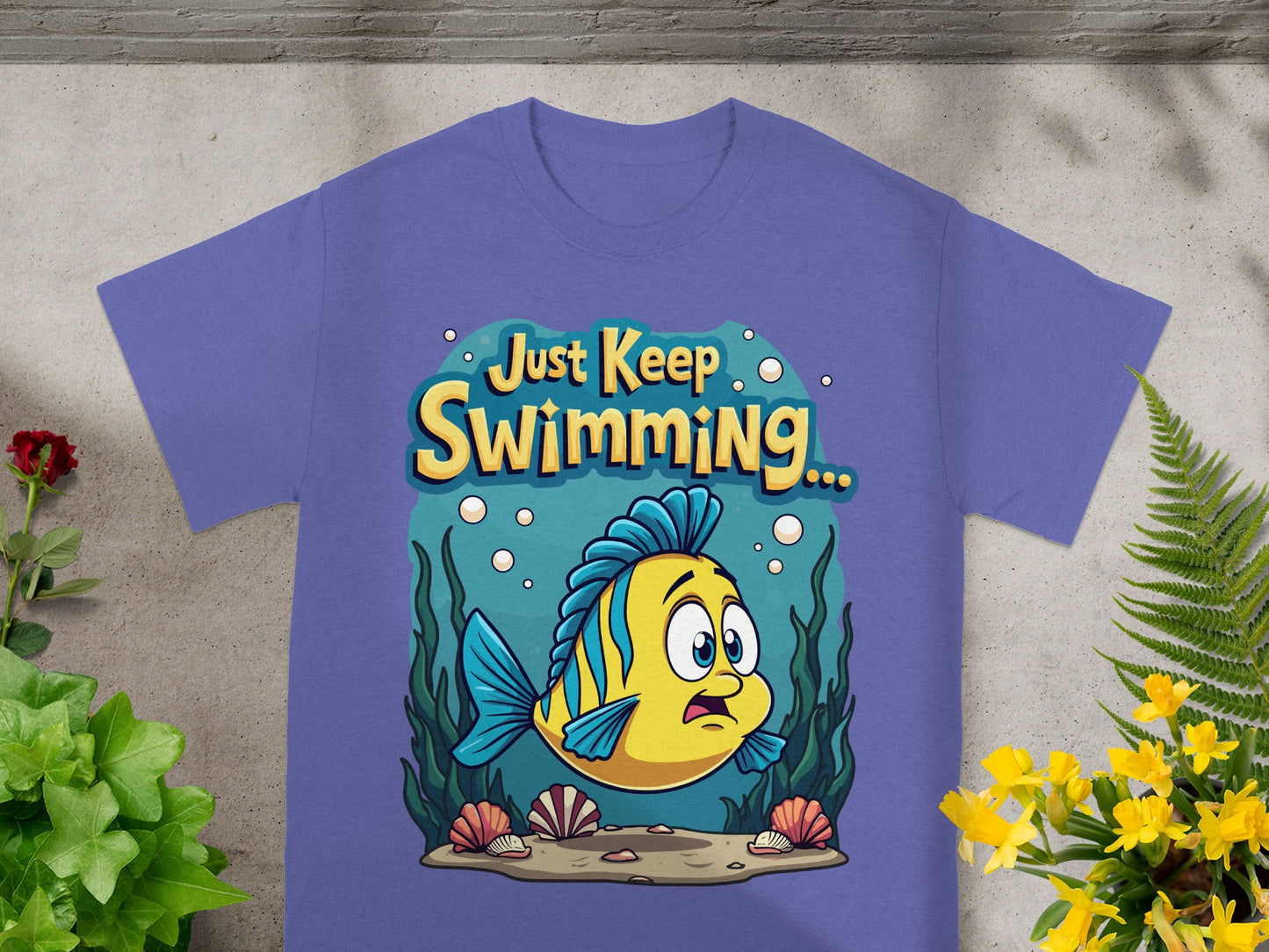 Purple t-shirt with yellow and blue fish and "Just Keep Swimming..." text.