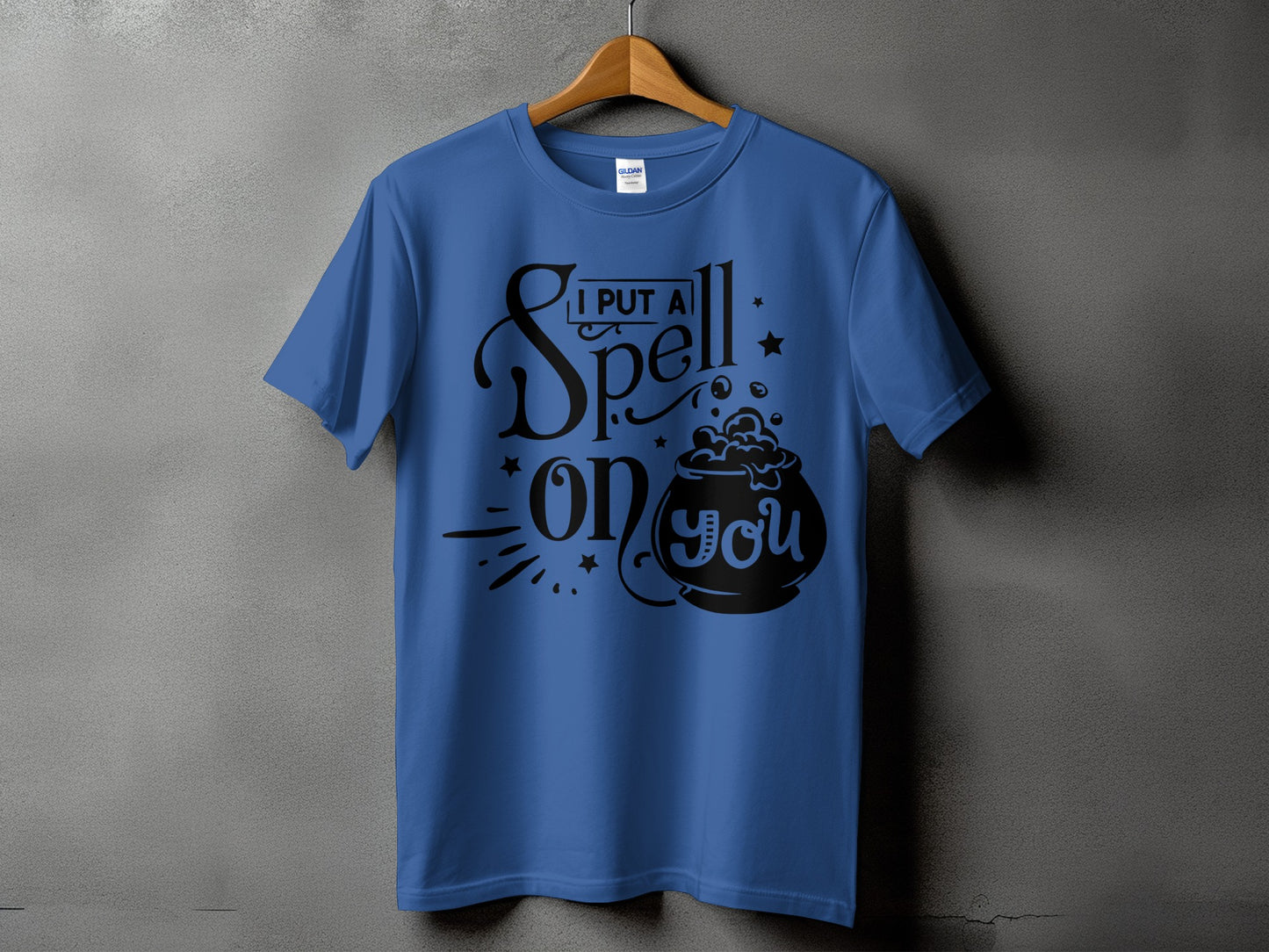 Blue t-shirt with black text reading "I PUT A Spell on you" and a cauldron graphic.