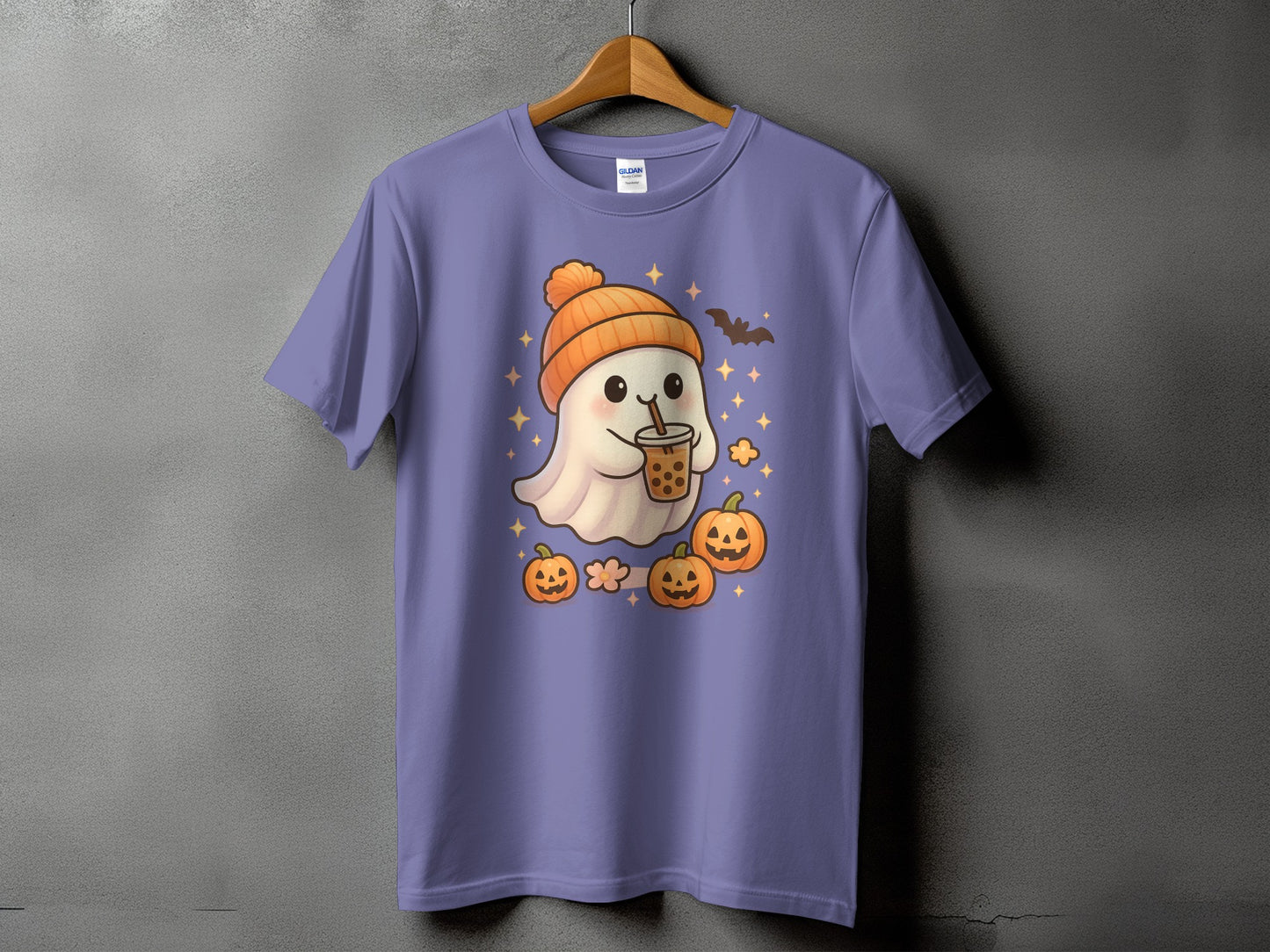 Purple t-shirt with a kawaii ghost in an orange hat holding bubble tea, surrounded by pumpkins and stars.