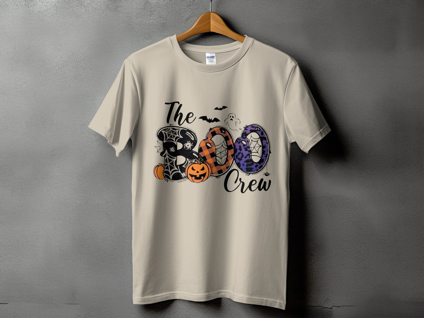 Light beige t-shirt with "The Boo Crew" Halloween graphic featuring pumpkins and spiders.