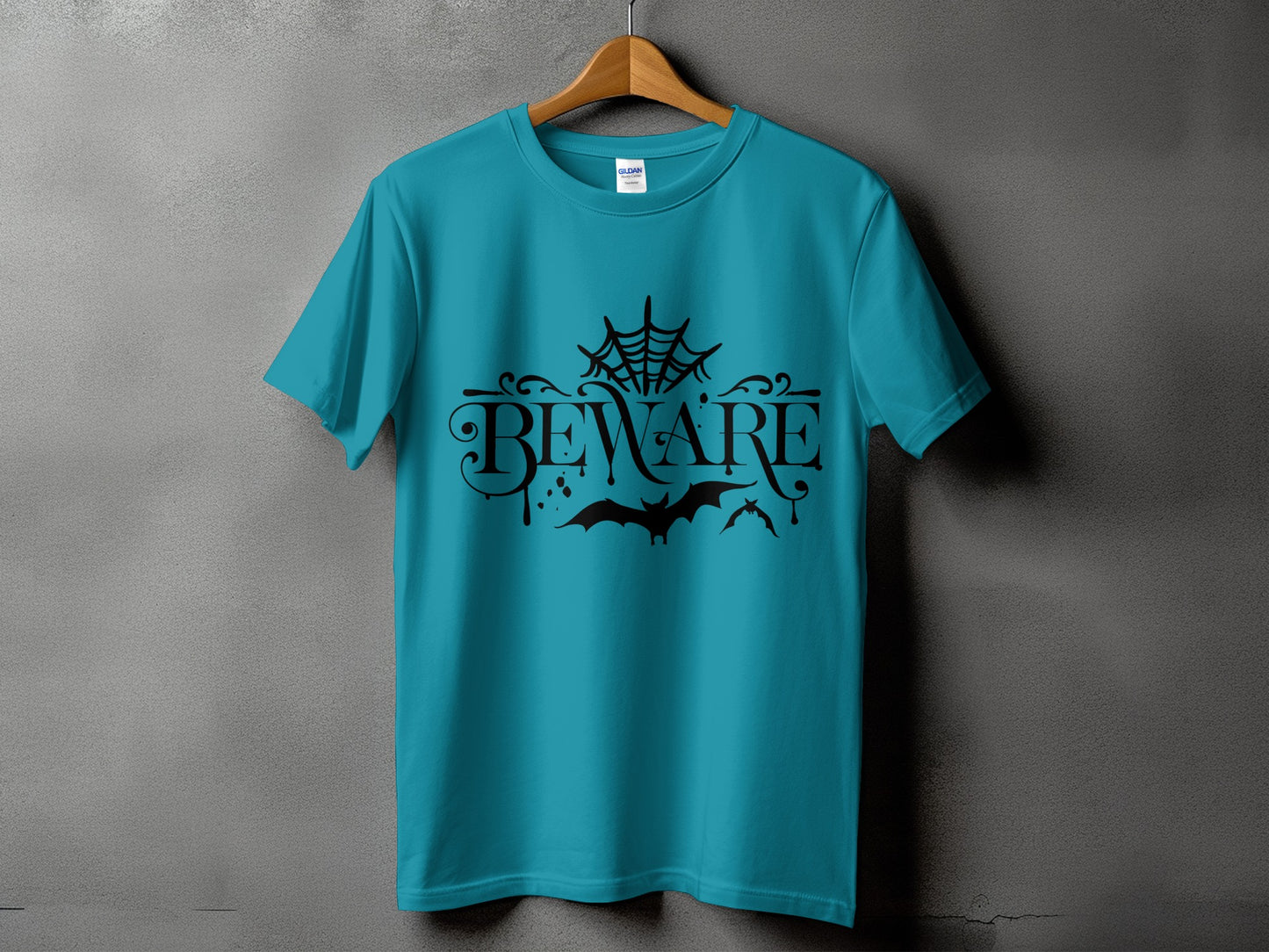 Teal t-shirt with black "Beware" text, spiderweb, and bats graphic.
