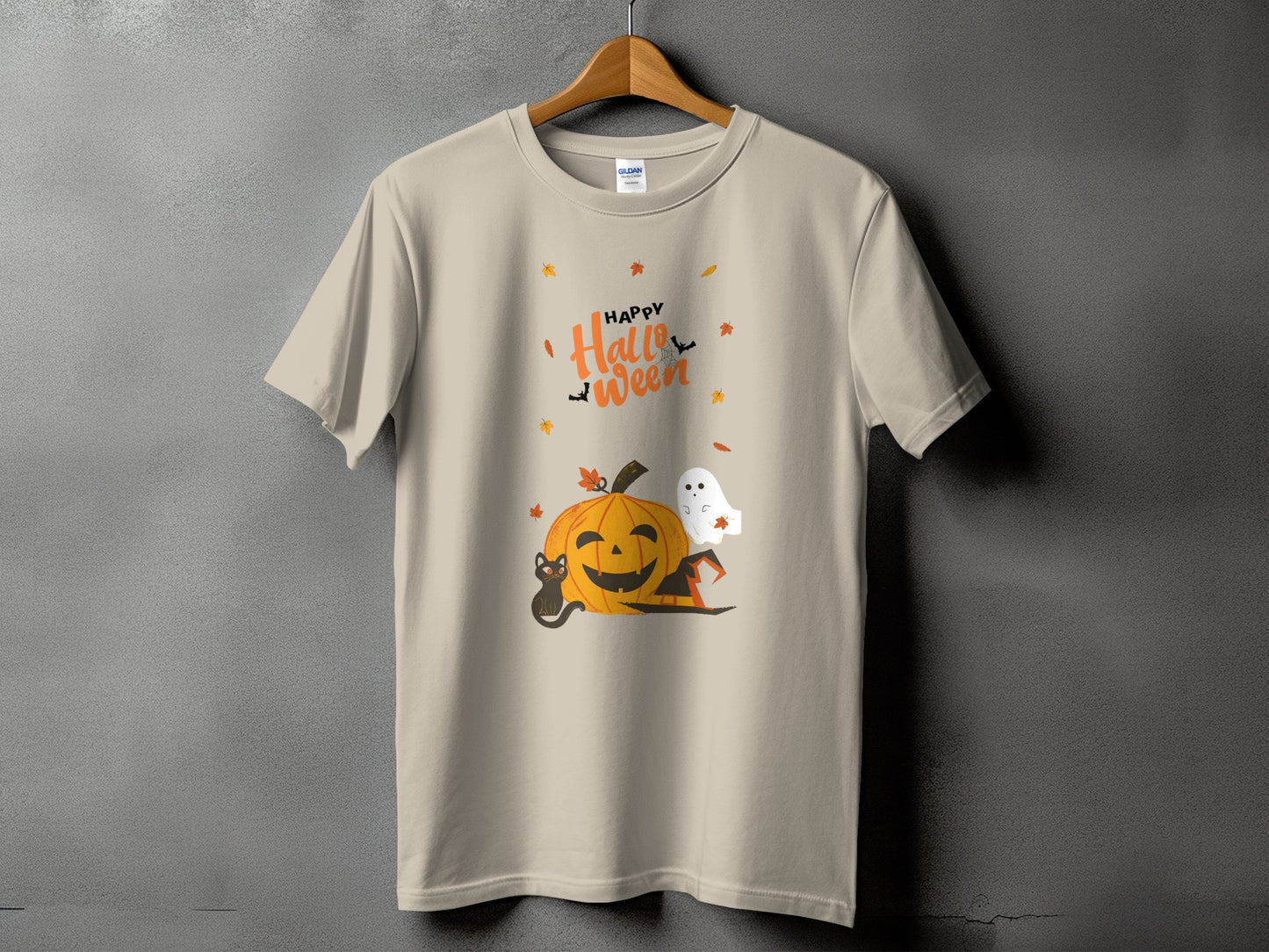 Light beige t-shirt with Halloween graphic featuring pumpkin, cat, ghost, and text.