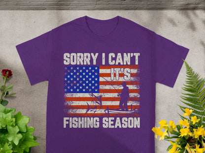 Purple t-shirt with distressed American flag and fishing graphics, text "Sorry I can't it's fishing season."