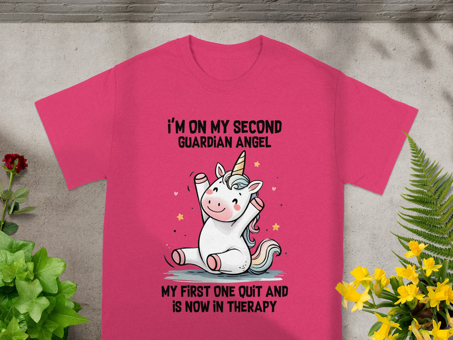 Pink t-shirt with a unicorn graphic and text "I'm on my second guardian angel".