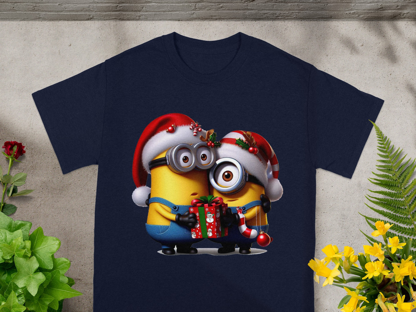 Two Minions in Santa hats hug a Christmas gift, one holding candy cane.