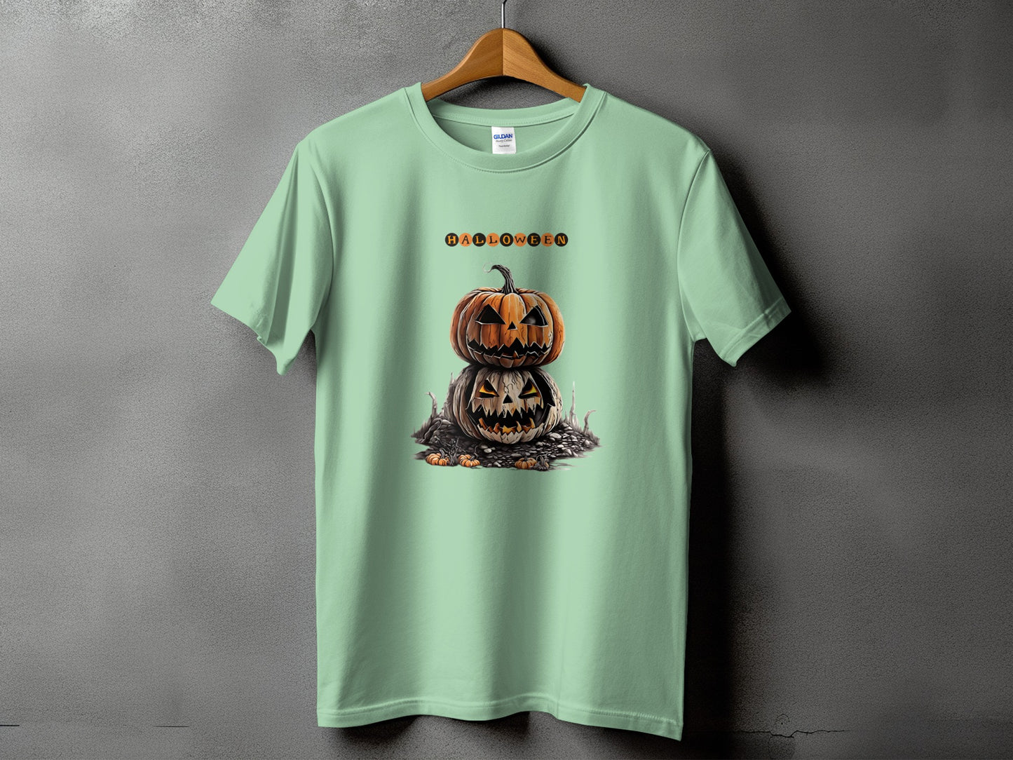 Light green t-shirt with stacked jack-o'-lanterns and the word HALLOWEEN.