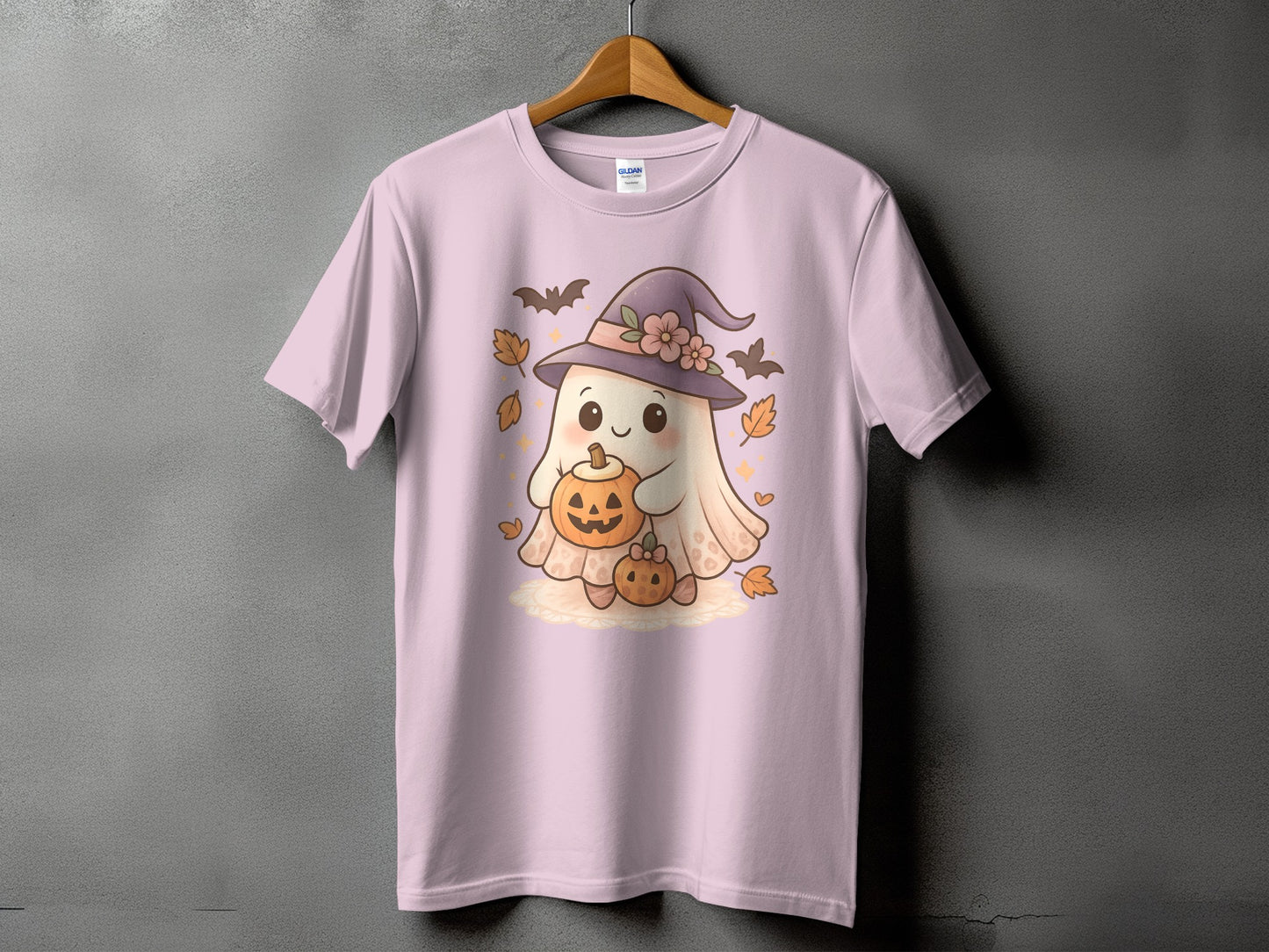 Pink t-shirt with a kawaii ghost holding pumpkins, wearing a witch hat.
