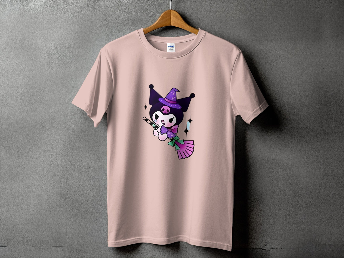 Pink t-shirt with Kuromi character wearing a witch hat and holding a broomstick.