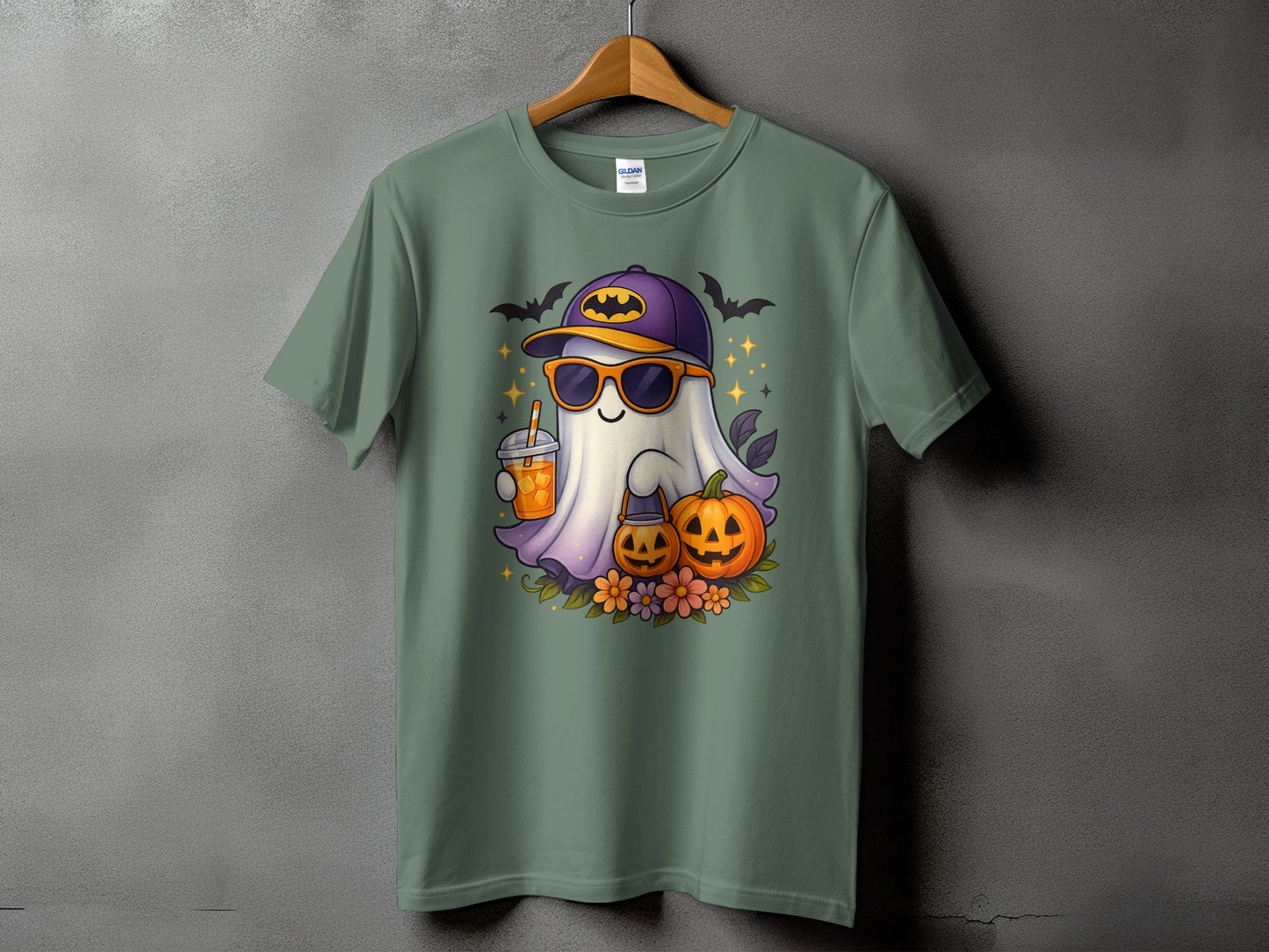Halloween ghost with sunglasses, baseball cap, drink, and pumpkins on a green t-shirt.