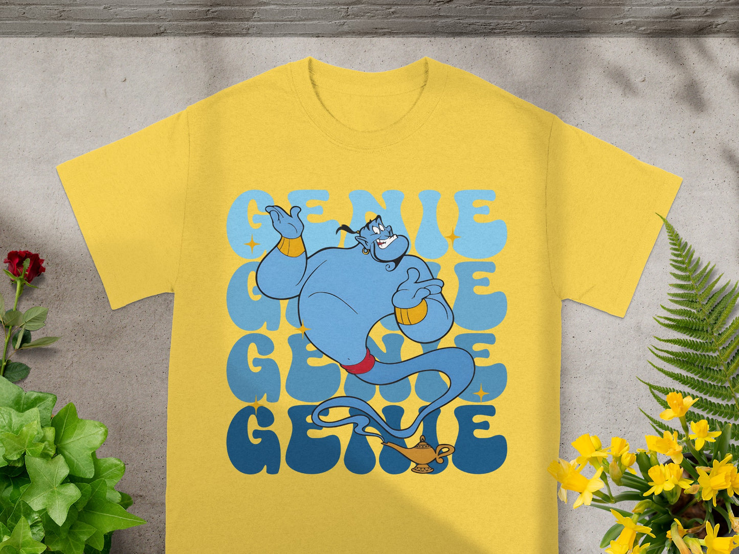 Yellow t-shirt with blue genie graphic and text "Genie".