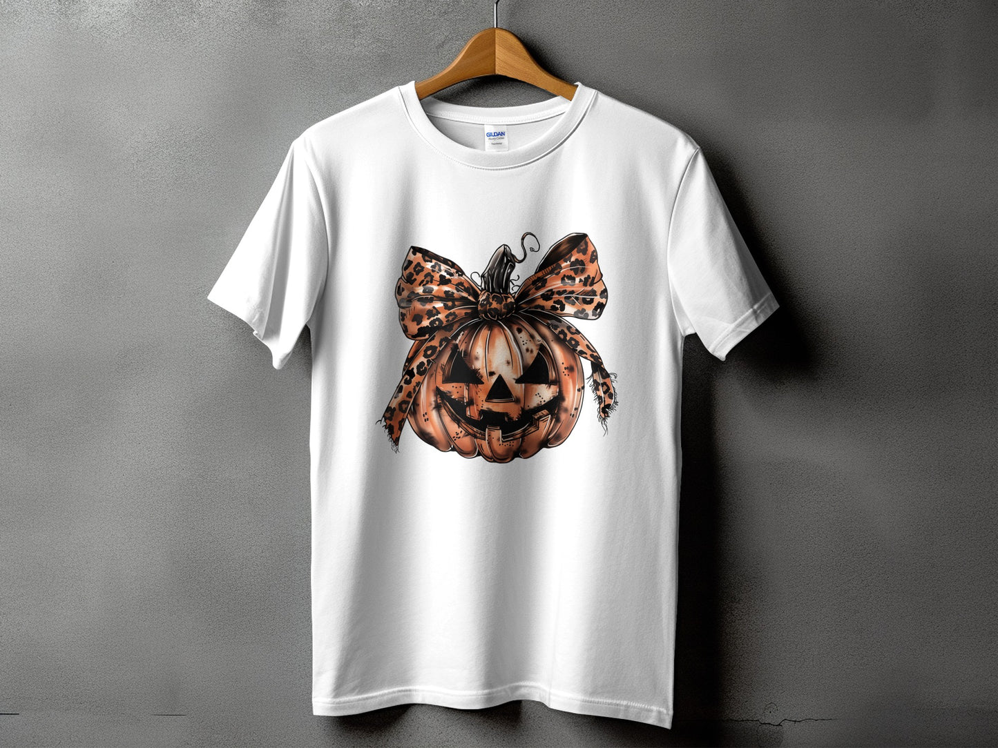 White t-shirt with a jack-o'-lantern graphic and leopard print bow.