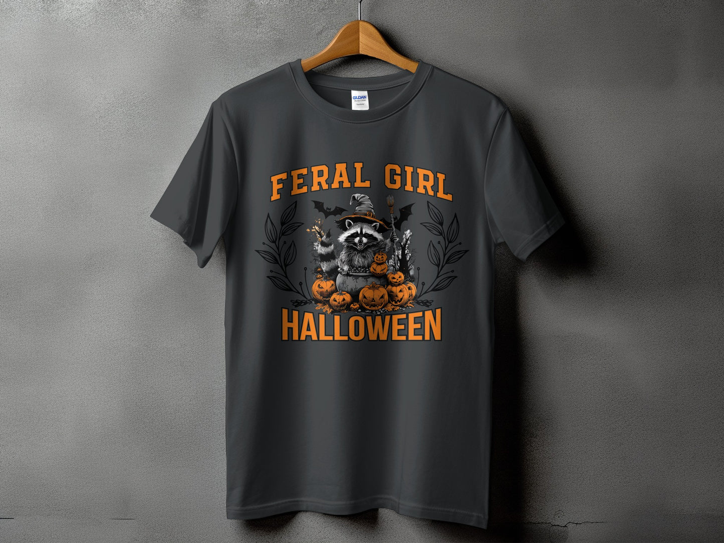 Dark grey t-shirt with a Halloween graphic of a raccoon, pumpkins, and text.