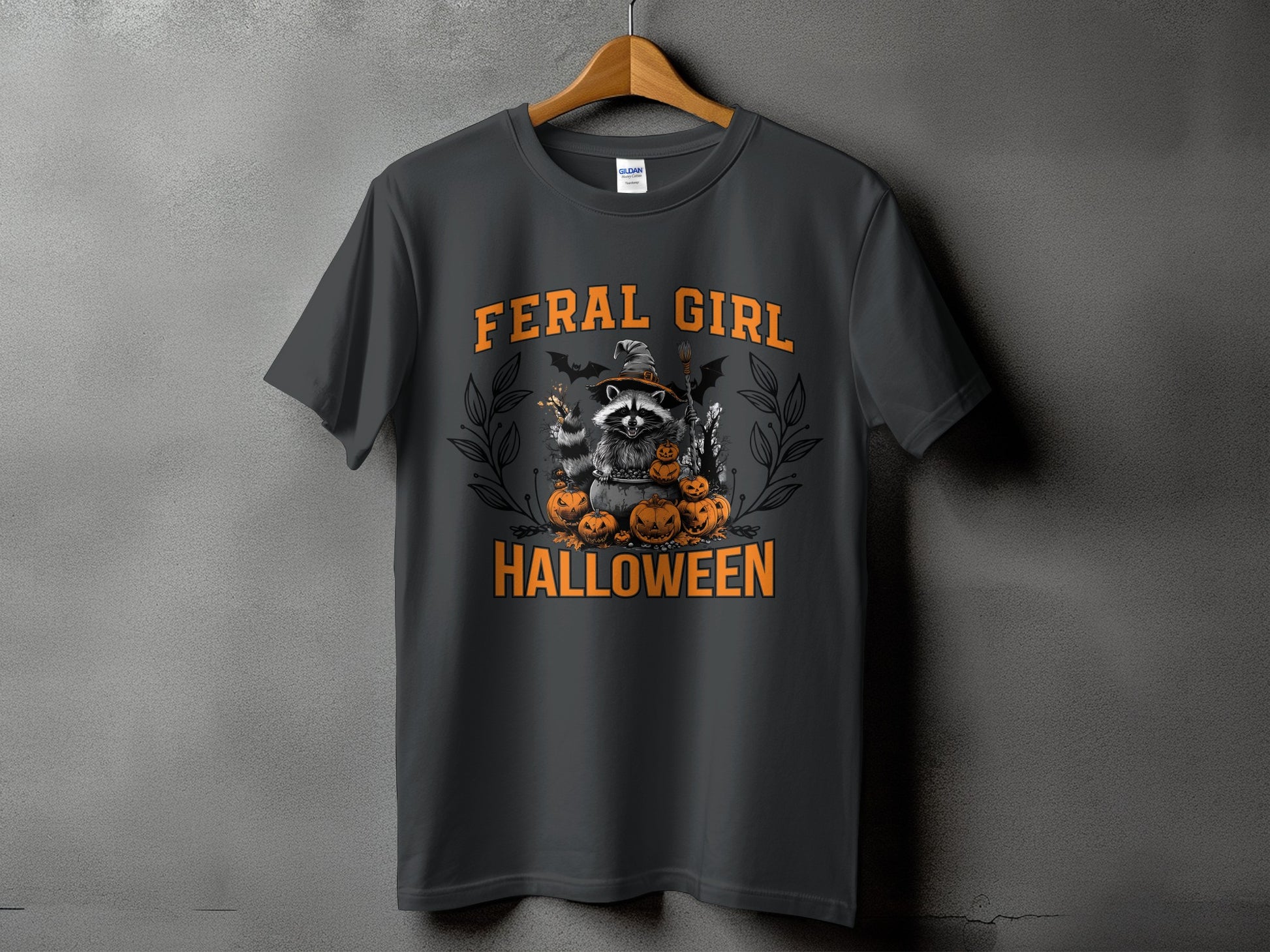 Dark grey t-shirt with a Halloween graphic of a raccoon, pumpkins, and text.
