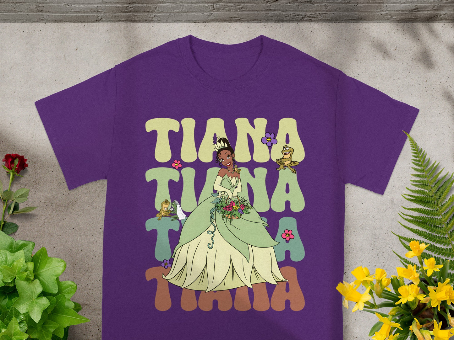 Purple t-shirt with "Tiana" in colorful letters and Tiana in her princess dress.