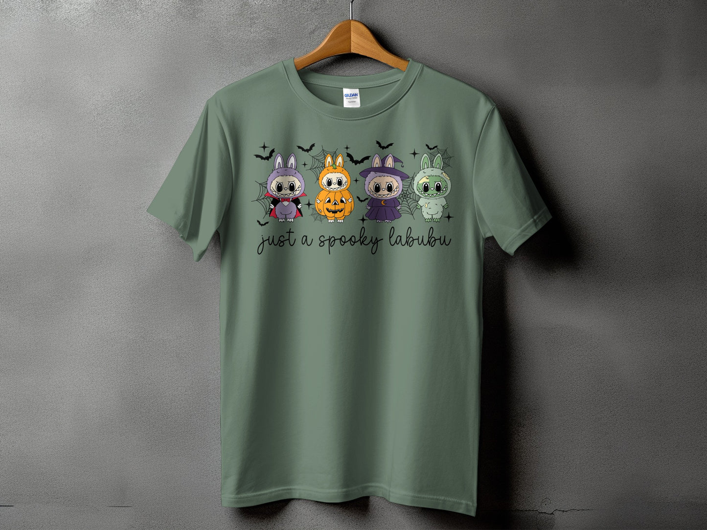 Green t-shirt with four spooky Labubu characters and text "just a spooky labubu".